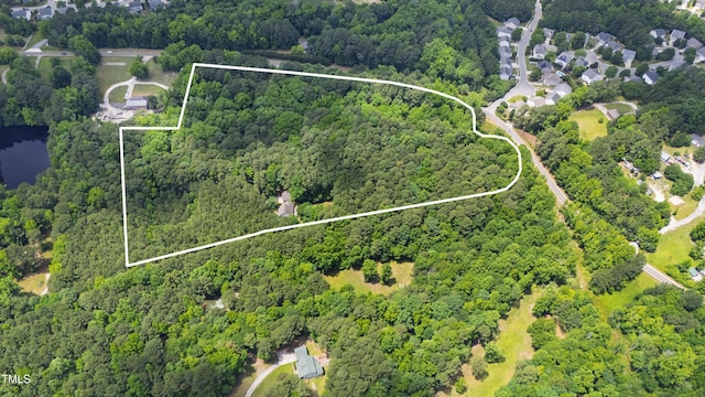 7104 Camp Branch Ln, Apex, NC 27502 - aerial view of property and surrounding area with a heavily wooded area and property parcel outlined