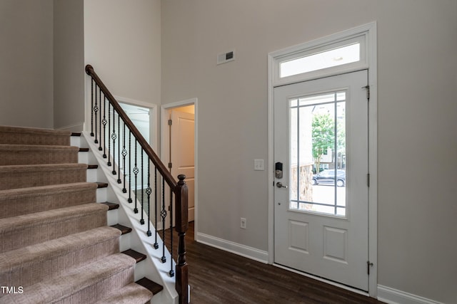 5638 Wade Park Blvd, Raleigh, NC 27607 - foyer entrance with dark wood finished floors, baseboards, stairs, and a high ceiling