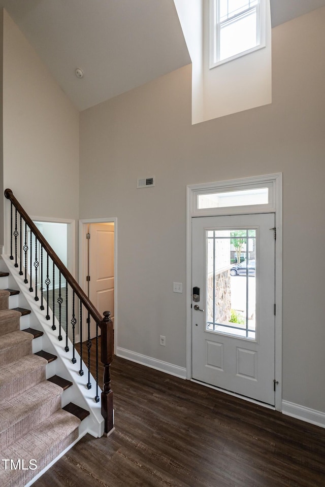 5638 Wade Park Blvd, Raleigh, NC 27607 - foyer entrance with a towering ceiling, baseboards, dark wood-style floors, and stairs