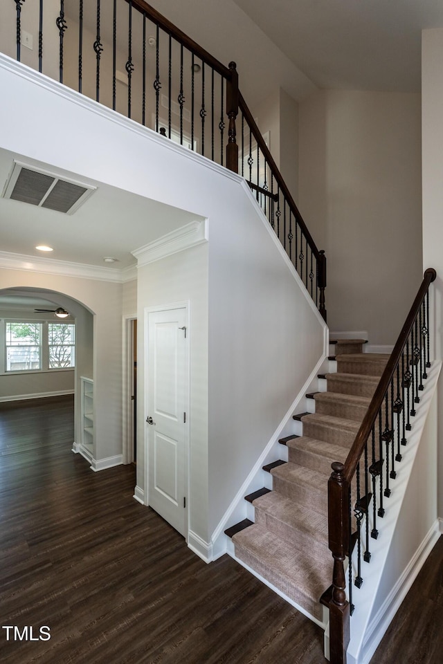 5638 Wade Park Blvd, Raleigh, NC 27607 - staircase featuring wood finished floors, arched walkways, baseboards, and crown molding
