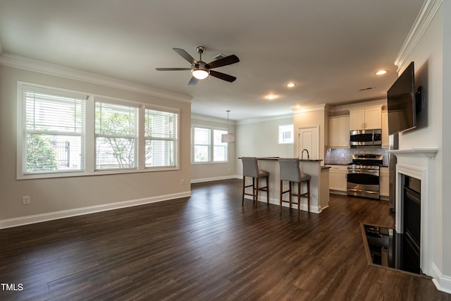 5638 Wade Park Blvd, Raleigh, NC 27607 - kitchen with appliances with stainless steel finishes, ceiling fan, a breakfast bar area, tasteful backsplash, and dark wood-type flooring