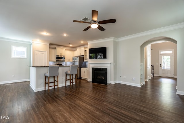 5638 Wade Park Blvd, Raleigh, NC 27607 - living area featuring ornamental molding, a ceiling fan, arched walkways, dark wood-style floors, and baseboards