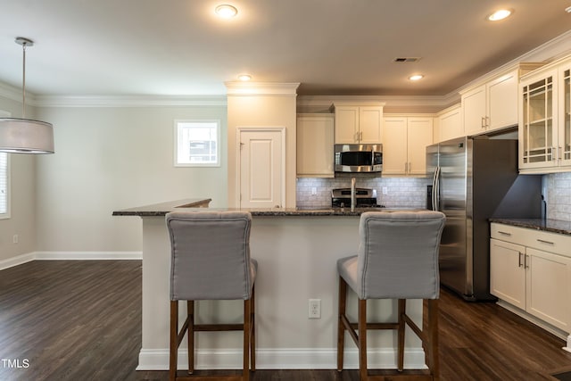 5638 Wade Park Blvd, Raleigh, NC 27607 - kitchen featuring stainless steel appliances, a breakfast bar, glass insert cabinets, backsplash, and ornamental molding