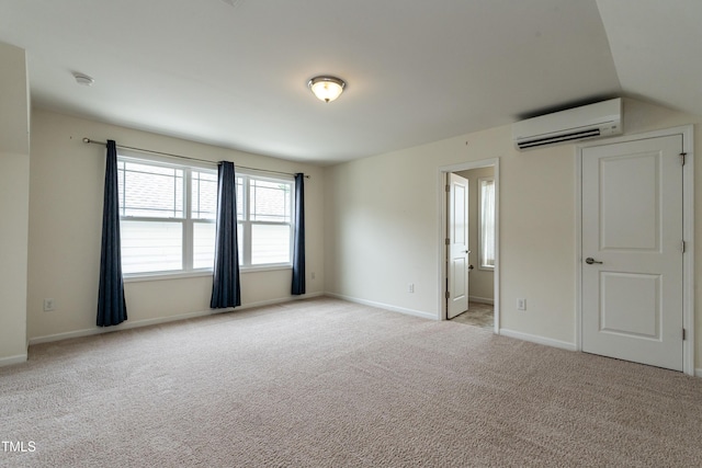 5638 Wade Park Blvd, Raleigh, NC 27607 - unfurnished bedroom featuring a wall mounted air conditioner, light carpet, and baseboards