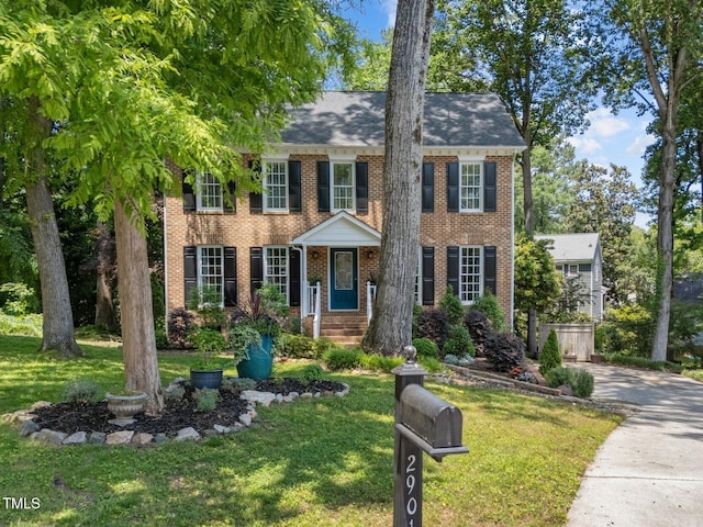 2901 Ceremonial Ct, Raleigh, NC 27615 - view of front of house featuring a front yard, brick siding, and driveway