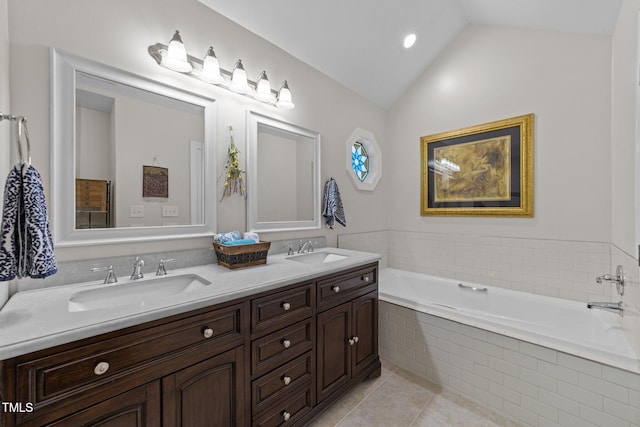 2901 Ceremonial Ct, Raleigh, NC 27615 - bathroom featuring double vanity, tile patterned floors, vaulted ceiling, and a bath