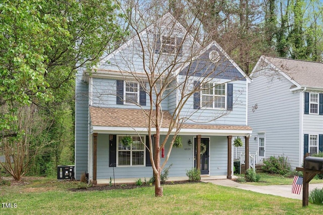 4520 Timberhurst Dr, Raleigh, NC 27612 - view of front facade with a front yard, a shingled roof, and a porch