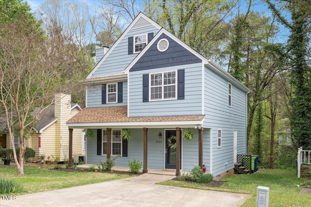 4520 Timberhurst Dr, Raleigh, NC 27612 - view of front of home with a porch, a front yard, and a chimney