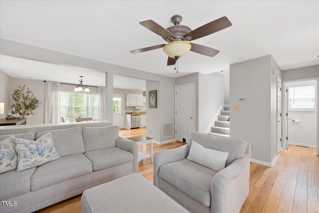 4520 Timberhurst Dr, Raleigh, NC 27612 - living room featuring light wood-style flooring, a chandelier, and baseboards