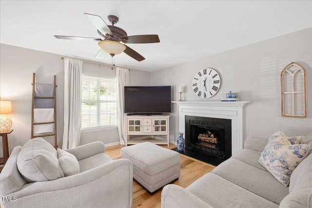 4520 Timberhurst Dr, Raleigh, NC 27612 - living room with light wood-style floors, a ceiling fan, and a fireplace with flush hearth