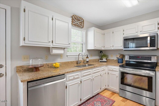 4520 Timberhurst Dr, Raleigh, NC 27612 - kitchen featuring stainless steel appliances, a sink, and white cabinets