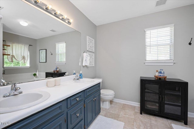4520 Timberhurst Dr, Raleigh, NC 27612 - bathroom with toilet, double vanity, and baseboards