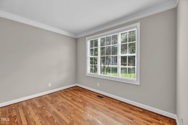 8140 Consella Way, Willow Springs, NC 27592 - unfurnished room featuring baseboards, healthy amount of natural light, light wood-style flooring, and ornamental molding