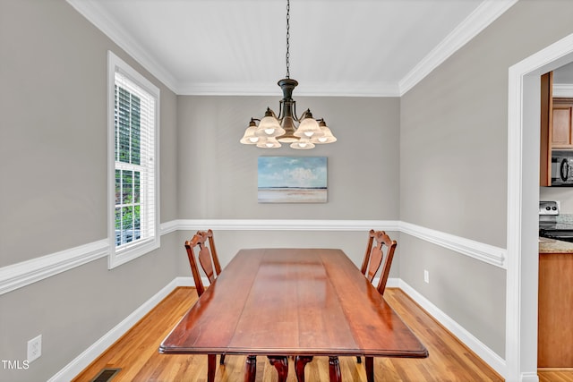 8140 Consella Way, Willow Springs, NC 27592 - dining area featuring light wood-style flooring, a chandelier, crown molding, and baseboards