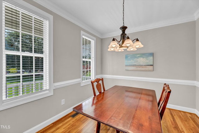 8140 Consella Way, Willow Springs, NC 27592 - unfurnished dining area featuring a chandelier, wood finished floors, crown molding, and baseboards