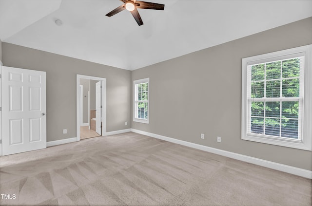 8140 Consella Way, Willow Springs, NC 27592 - unfurnished bedroom featuring light carpet, baseboards, vaulted ceiling, connected bathroom, and a ceiling fan