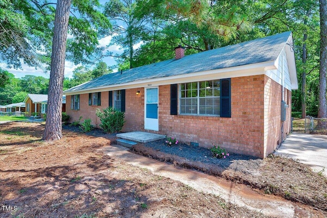 8004 Summit Dr, Goldsboro, NC 27530 - ranch-style house with a chimney, brick siding, and roof with shingles