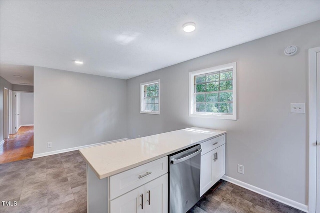8004 Summit Dr, Goldsboro, NC 27530 - kitchen featuring stainless steel dishwasher, a peninsula, white cabinetry, light countertops, and recessed lighting