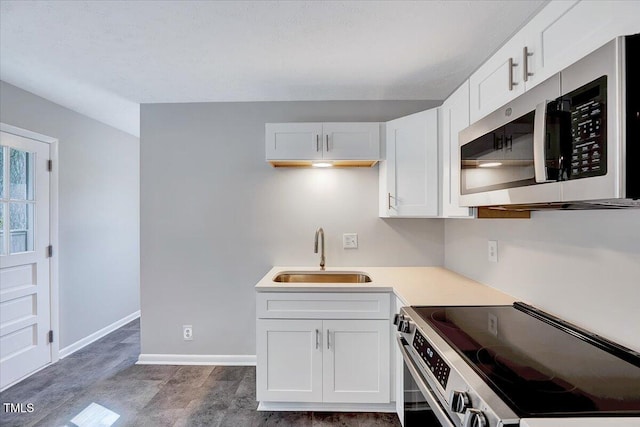8004 Summit Dr, Goldsboro, NC 27530 - kitchen featuring stainless steel appliances, a sink, white cabinets, and baseboards