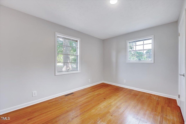 8004 Summit Dr, Goldsboro, NC 27530 - empty room featuring healthy amount of natural light, baseboards, and light wood-style floors