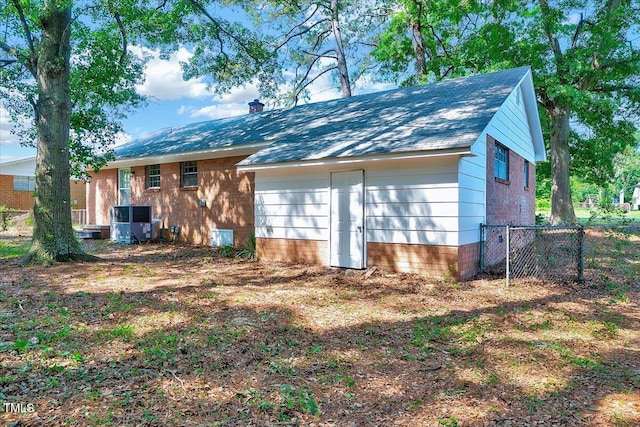 8004 Summit Dr, Goldsboro, NC 27530 - back of property with a chimney, central AC unit, and brick siding