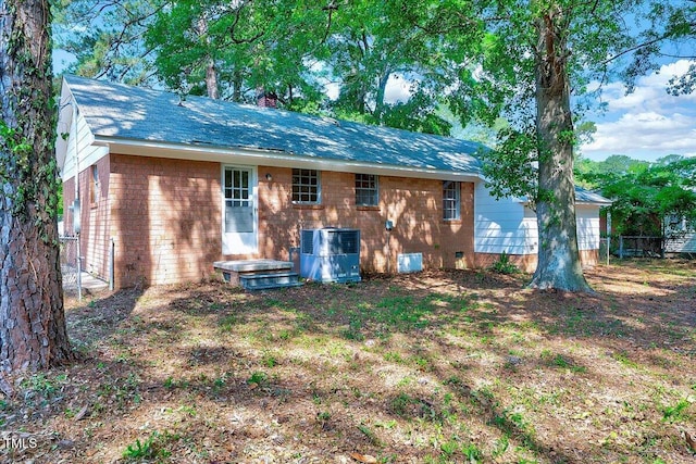 8004 Summit Dr, Goldsboro, NC 27530 - back of property featuring central air condition unit, brick siding, a chimney, and crawl space
