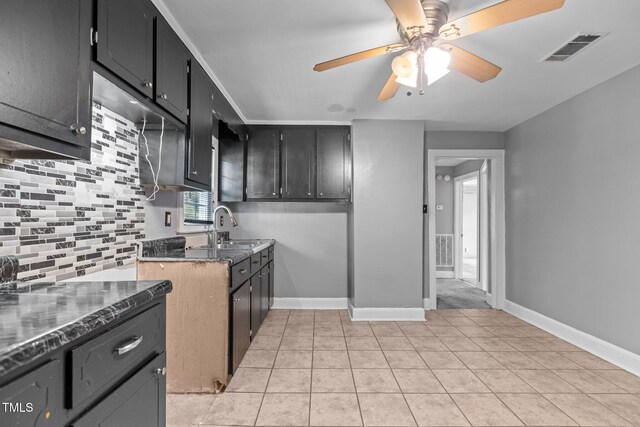 1818 Cecil St, Durham, NC 27707 - kitchen featuring ceiling fan, light tile patterned flooring, dark stone countertops, and dark cabinets