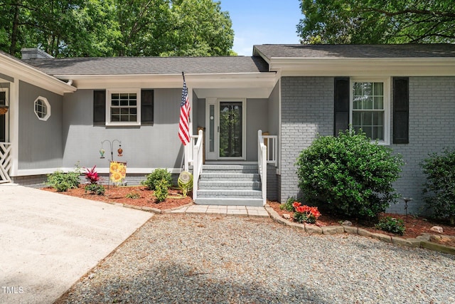 815 Walter Bright Rd, Sanford, NC 27330 - view of front facade with brick siding, covered porch, and roof with shingles