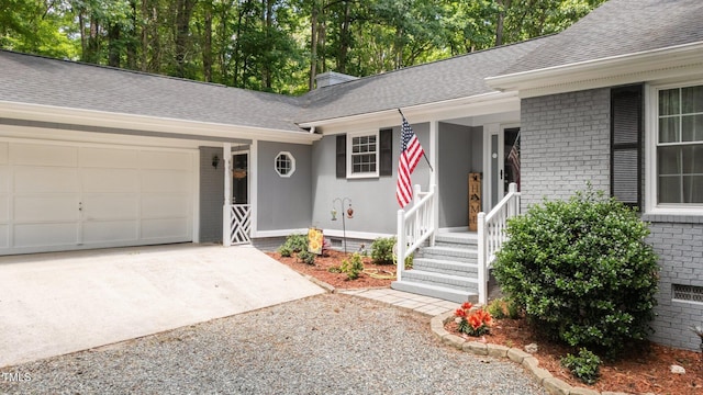 815 Walter Bright Rd, Sanford, NC 27330 - doorway to property featuring driveway, brick siding, an attached garage, and roof with shingles