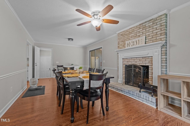 815 Walter Bright Rd, Sanford, NC 27330 - dining room with a ceiling fan, wood finished floors, a fireplace, crown molding, and a textured ceiling