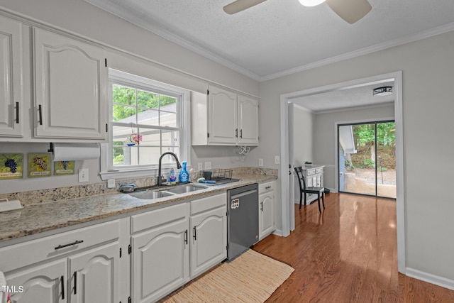 815 Walter Bright Rd, Sanford, NC 27330 - kitchen featuring dishwasher, a sink, white cabinets, crown molding, and healthy amount of natural light