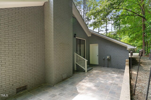 815 Walter Bright Rd, Sanford, NC 27330 - view of property exterior featuring brick siding, crawl space, a patio, and entry steps