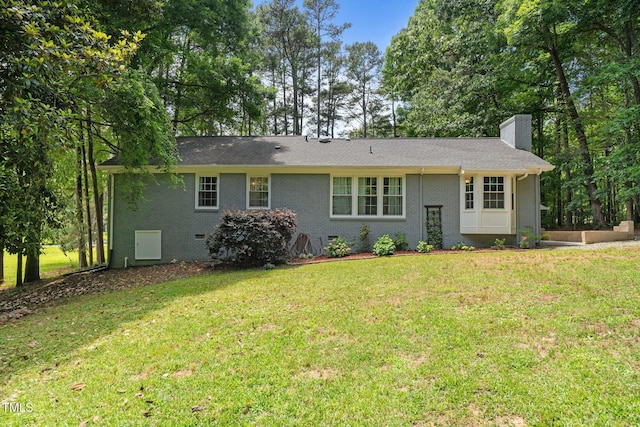 815 Walter Bright Rd, Sanford, NC 27330 - view of front of home with a chimney, a front lawn, and brick siding