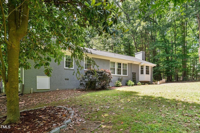 815 Walter Bright Rd, Sanford, NC 27330 - tri-level home with a chimney, brick siding, a front lawn, and crawl space