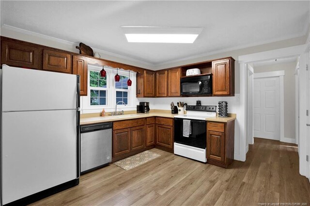 4101 Vann Dr, Lumberton, NC 28358 - kitchen with freestanding refrigerator, electric range oven, dishwasher, black microwave, and a sink
