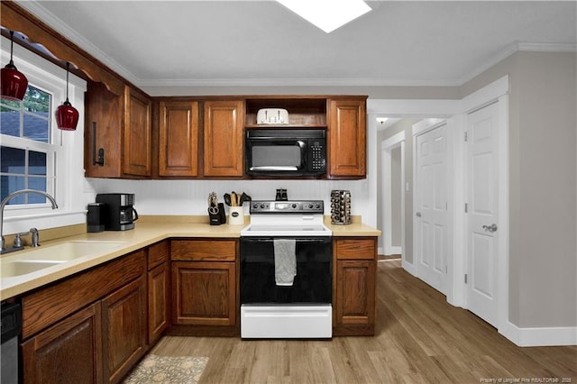 4101 Vann Dr, Lumberton, NC 28358 - kitchen featuring black microwave, range with electric stovetop, a sink, light wood-style flooring, and crown molding