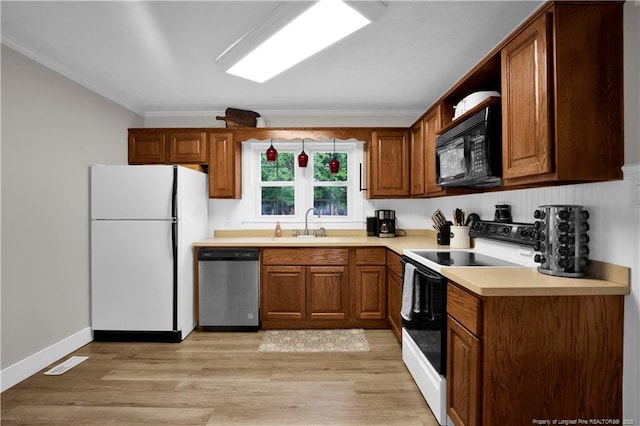 4101 Vann Dr, Lumberton, NC 28358 - kitchen featuring white appliances, ornamental molding, brown cabinets, and light wood-type flooring
