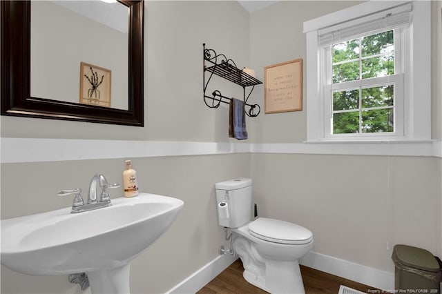 4101 Vann Dr, Lumberton, NC 28358 - half bathroom featuring baseboards, wood finished floors, a sink, and toilet