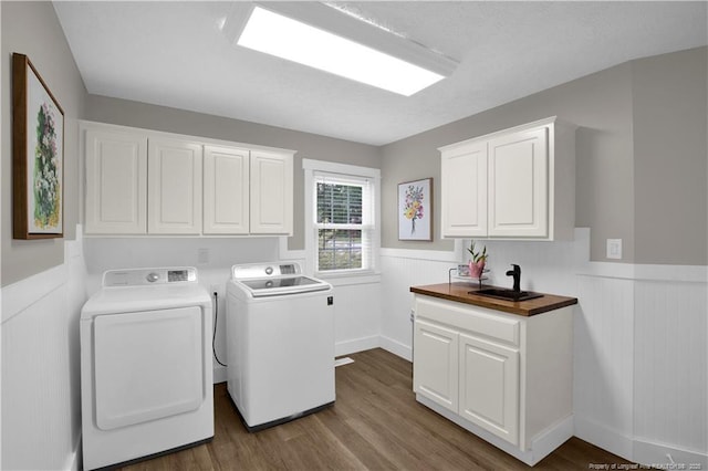 4101 Vann Dr, Lumberton, NC 28358 - laundry area with a wainscoted wall, washing machine and dryer, dark wood-style flooring, and cabinet space