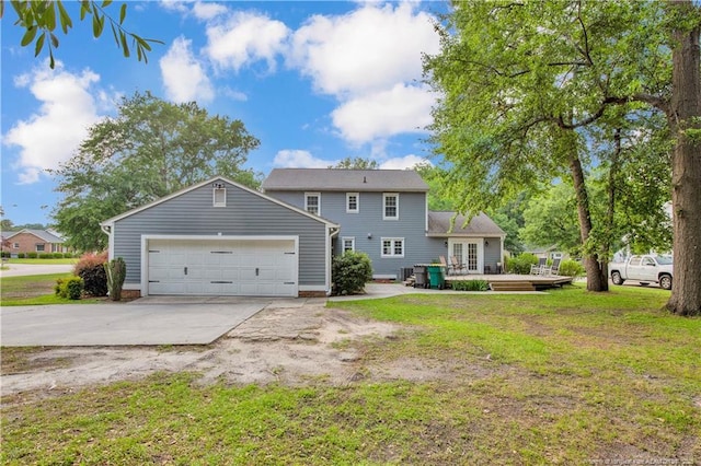 4101 Vann Dr, Lumberton, NC 28358 - back of house with a yard, a wooden deck, a garage, and driveway