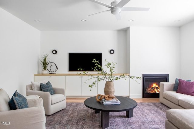 1405 Watts St, Durham, NC 27701 - living area with light wood finished floors, a ceiling fan, a glass covered fireplace, and recessed lighting