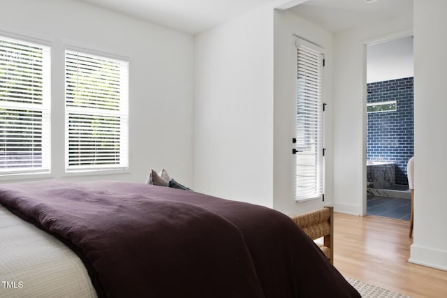 1405 Watts St, Durham, NC 27701 - bedroom with light wood-style flooring, ensuite bathroom, and baseboards