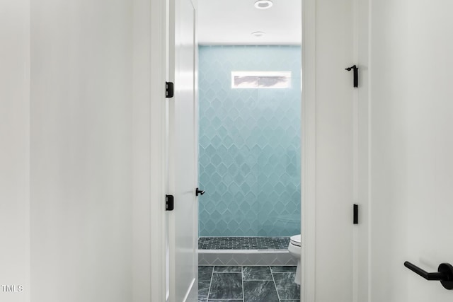 1405 Watts St, Durham, NC 27701 - bathroom featuring a stall shower, toilet, and marble look tiles