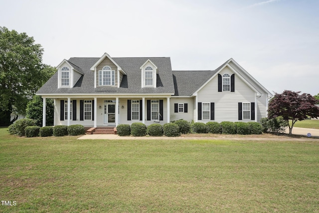 105 Bagley Ln, Dunn, NC 28334 - cape cod-style house featuring a front yard, a shingled roof, and covered porch