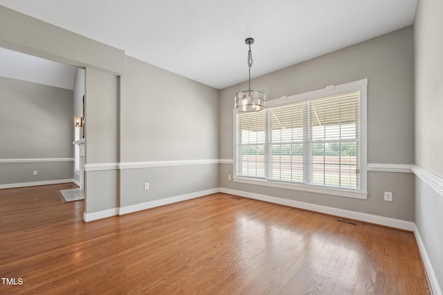 105 Bagley Ln, Dunn, NC 28334 - empty room featuring a chandelier, baseboards, and wood finished floors