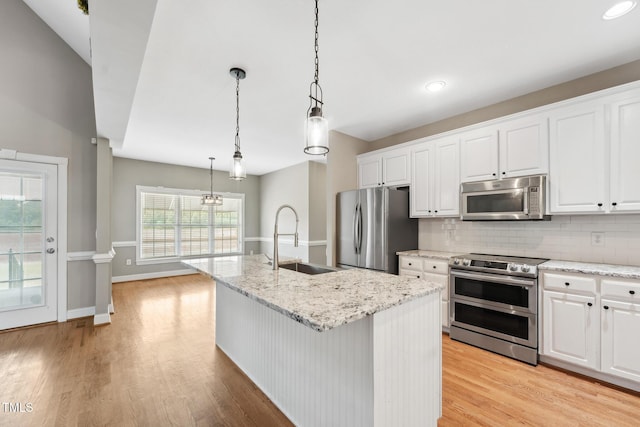 105 Bagley Ln, Dunn, NC 28334 - kitchen with appliances with stainless steel finishes, a sink, light wood-type flooring, white cabinets, and recessed lighting