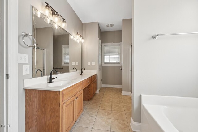 105 Bagley Ln, Dunn, NC 28334 - full bathroom with tile patterned flooring, a bath, double vanity, a shower stall, and baseboards