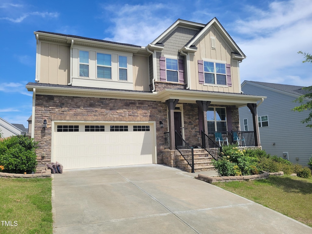 241 Fishburn Dr, Apex, NC 27523 - craftsman inspired home with board and batten siding, stone siding, a porch, a garage, and concrete driveway