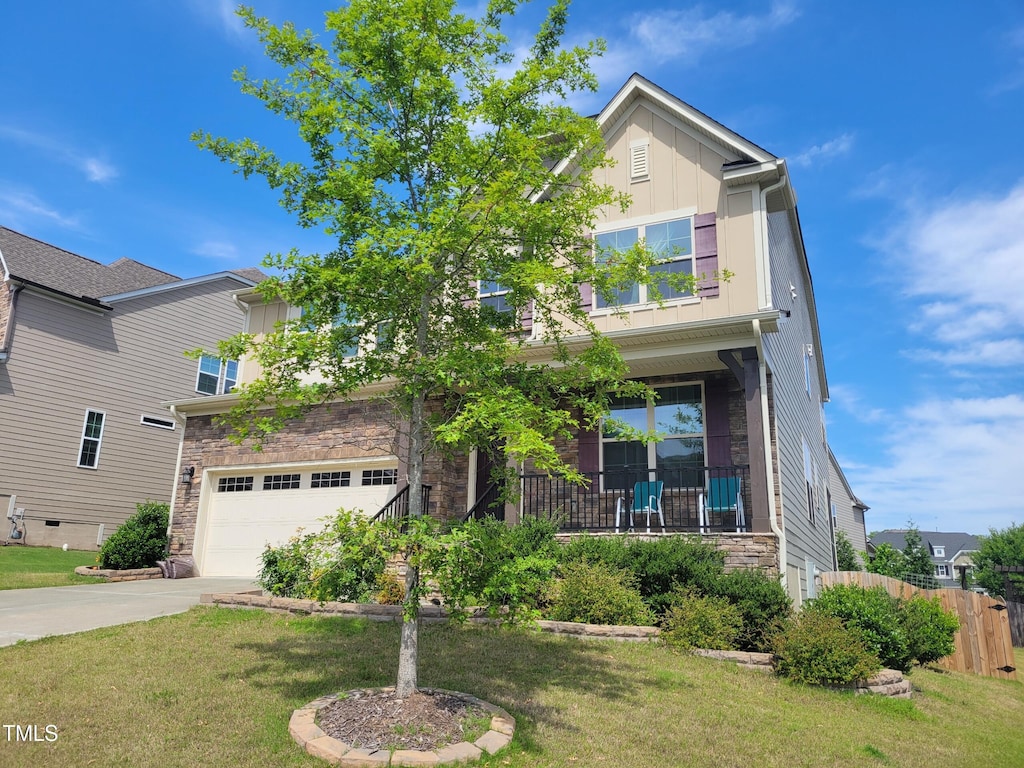 241 Fishburn Dr, Apex, NC 27523 - view of front facade with an attached garage, concrete driveway, board and batten siding, and stone siding