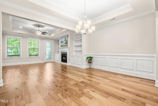 192 Glenpark Pl, Cary, NC 27511 - unfurnished living room with a raised ceiling, light wood finished floors, a chandelier, a lit fireplace, and ornamental molding
